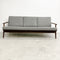 Gray sofa with wooden frame on a white background