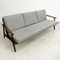 Gray sofa with wooden frame on a white floor