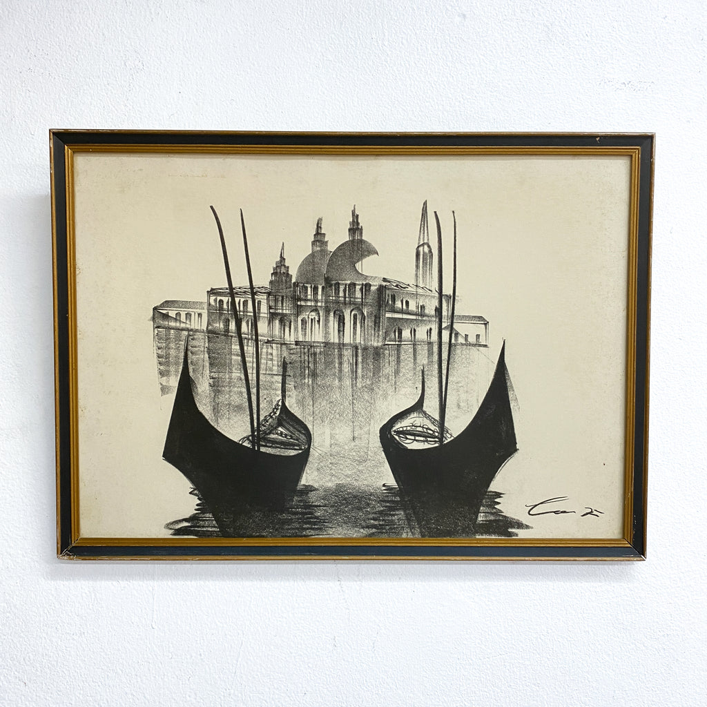 Framed artwork of gondolas on water with a cityscape in the background
