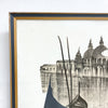 Framed artwork of a cityscape with domes and a boat on a river.