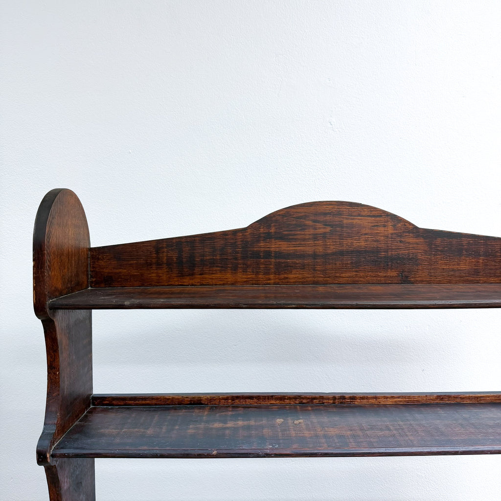Wooden shelf with a dark brown finish on a white background