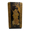 A vintage Japanese-style folding screen or cabinet featuring a black lacquered panel with gold and brown hand-painted illustration of a samurai, flanked by gold-patterned side panels, set against a plain white wall and gray floor.