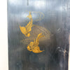 A dark, weathered black wooden panel featuring a hand-painted golden koi fish design with swirling water lines.