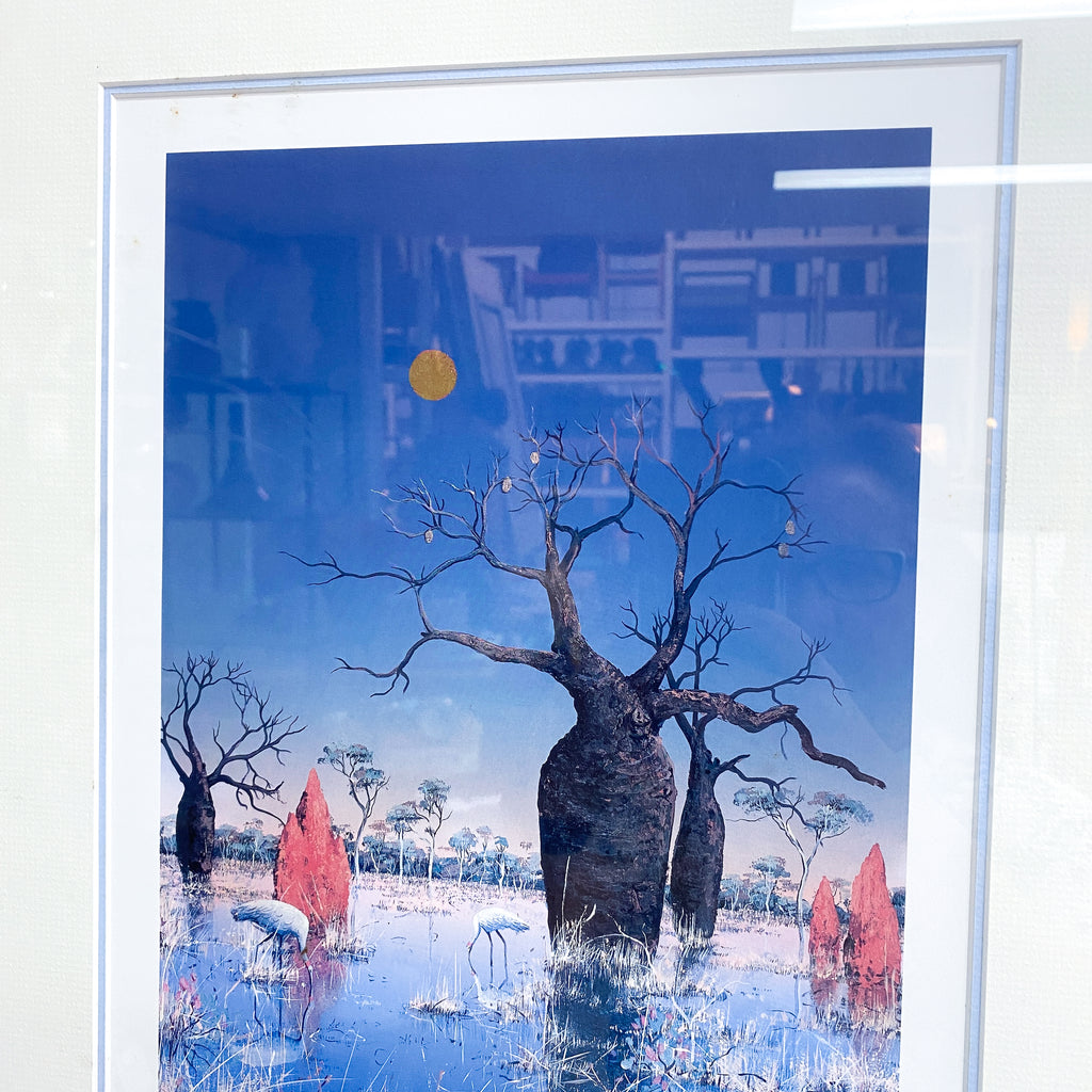 Framed artwork of a tree with a blue sky and yellow sun.