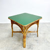 Wicker side table with a green top on a light gray background