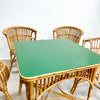 Rattan chairs and table with a green top on a light background