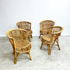 Four wicker chairs on a concrete floor with a white wall background