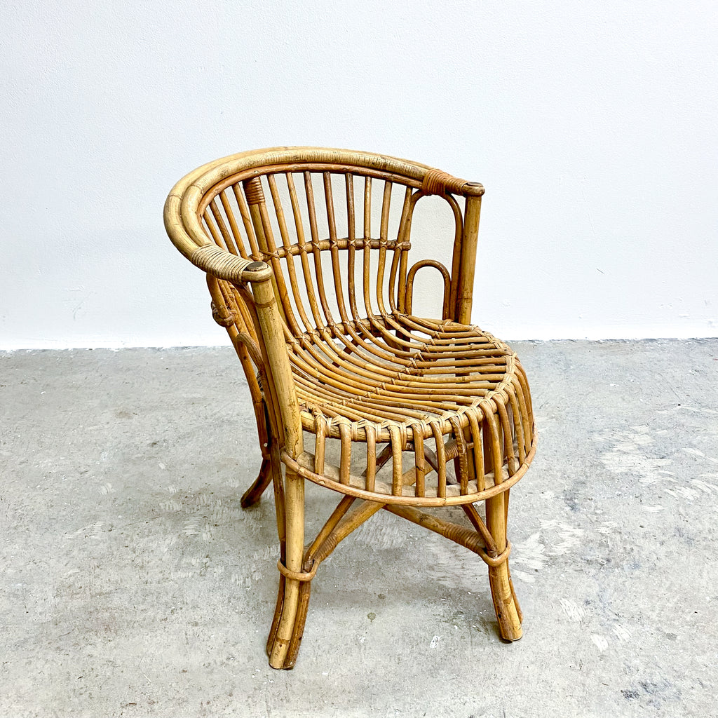Wicker chair on a concrete floor with a white background