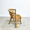 Wicker chair on a concrete floor with a white wall background