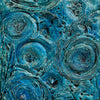 An abstract textured painting featuring swirling circular patterns in shades of teal, blue, and green, mounted on a white wall.