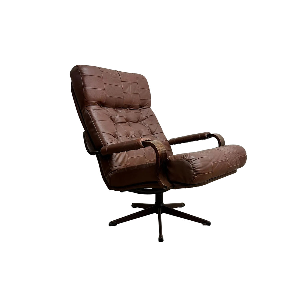 Brown leather armchair on a gray floor with a white background