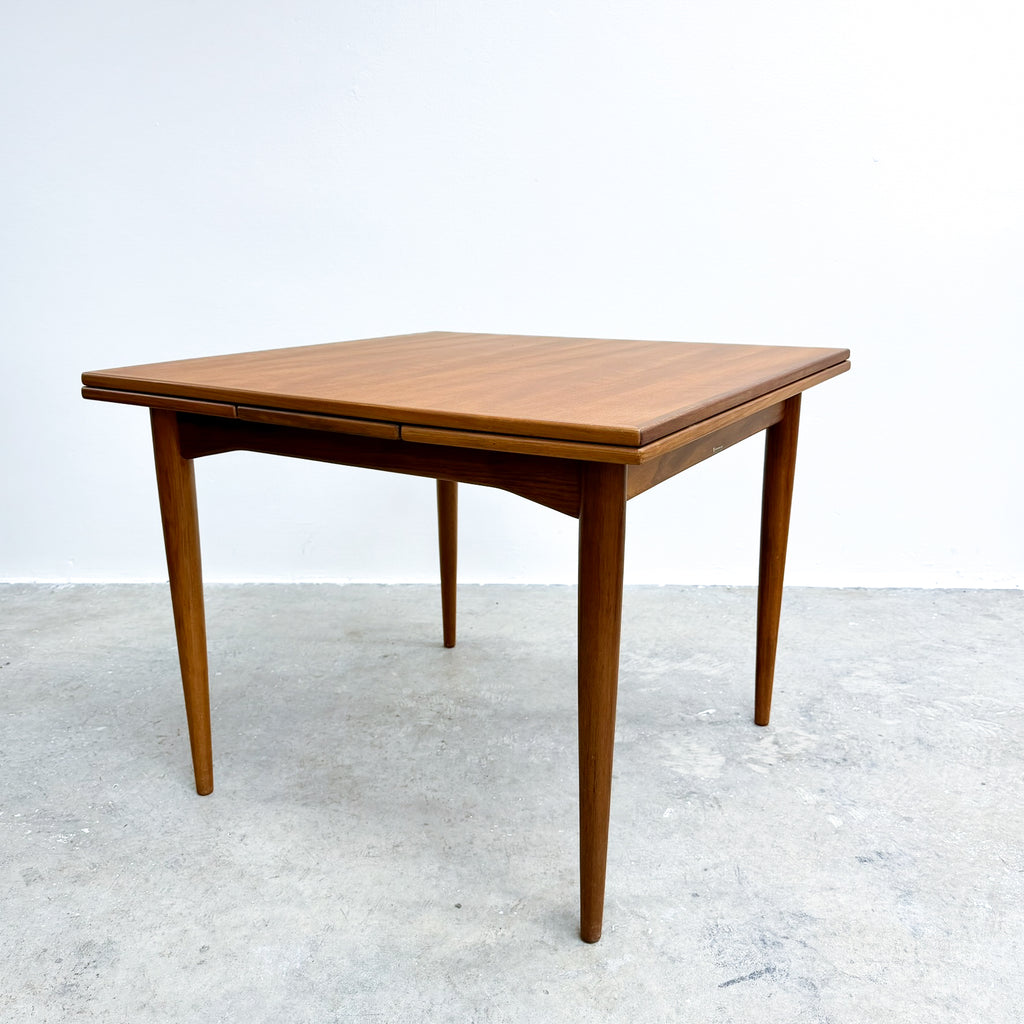 Wooden dining table on a white background