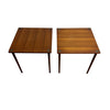 Two matching mid-century modern wooden end tables with square tops and tapered legs, shown side by side on a concrete floor against a white wall.