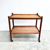 Wooden serving cart with two shelves on a white background