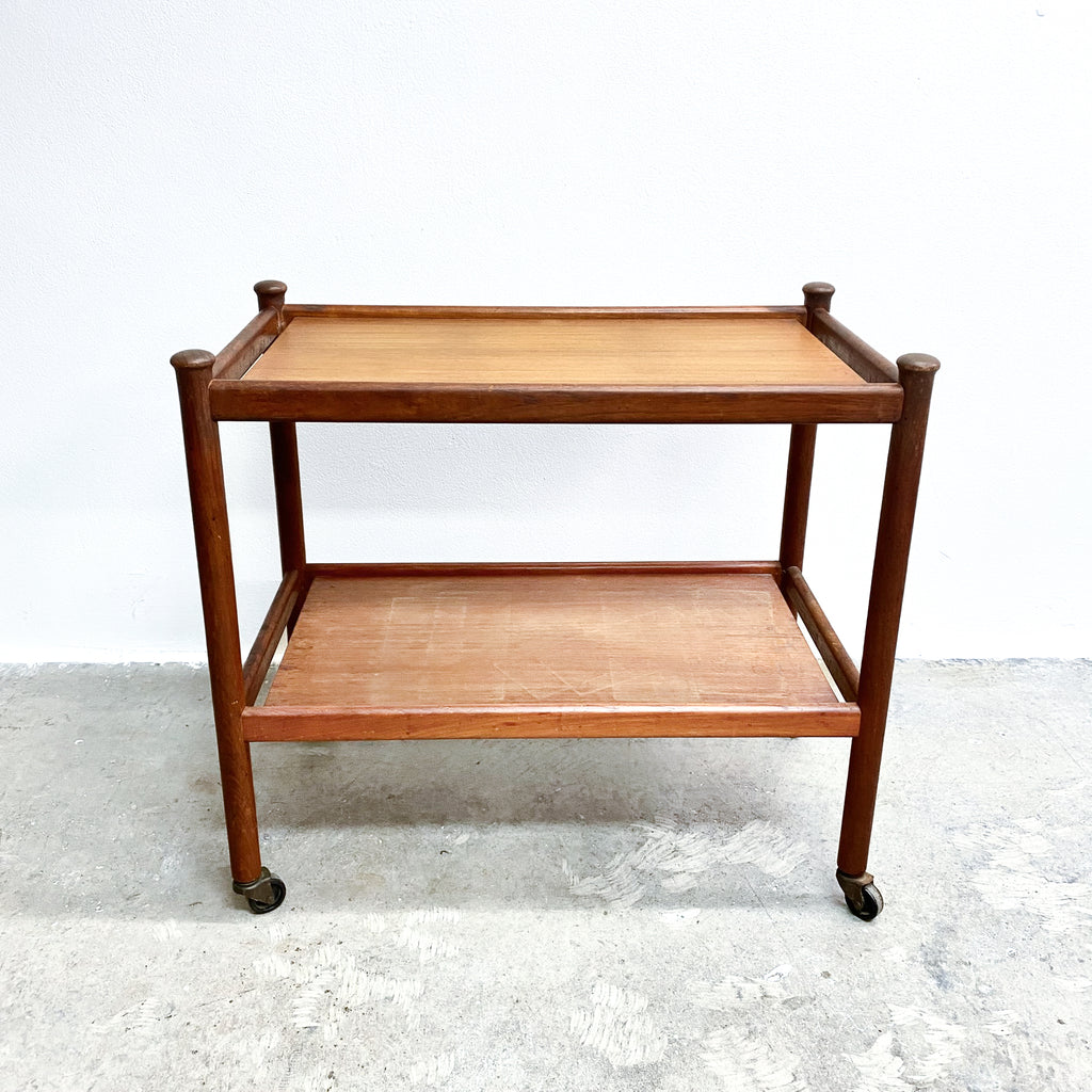 Wooden serving cart with two shelves on a white background