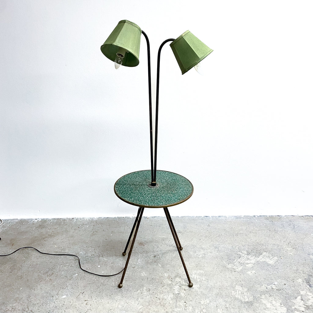 Green floor lamp with two lampshades on a white background
