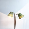 Double lamp with green shades on a light background