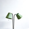 Green lamp with two curved arms on a white background