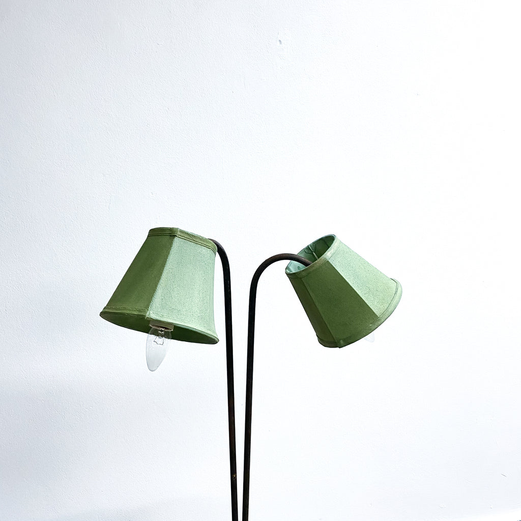Green lamp with two curved arms on a white background