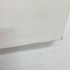 A close-up of a textured off-white or cream textured wall panel or wallpaper sample shown against a matching textured wall background.