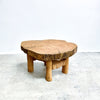 Wooden coffee table with a natural, rustic design on a white background