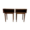 A pair of mid-century modern wooden side tables with open shelving and tapered legs, shown against a plain white wall and concrete floor.