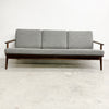 Gray sofa with wooden frame on a white background