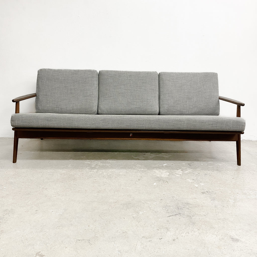 Gray sofa with wooden frame on a white background