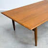 Wooden table with a polished surface on a concrete floor