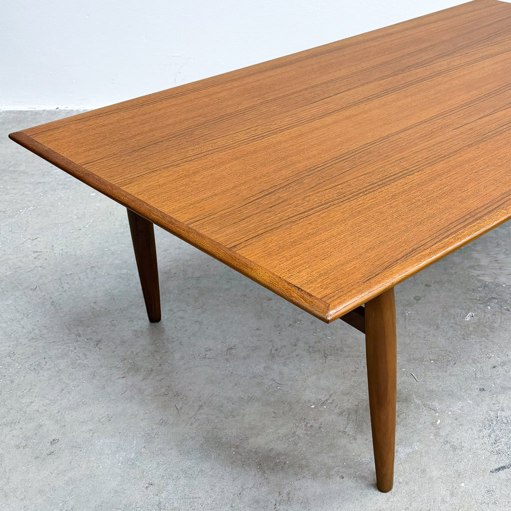Wooden table with a polished surface on a concrete floor