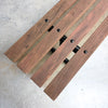Wooden bench with metal brackets on a concrete surface