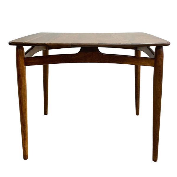 Wooden table with a curved top on a light gray background