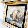 Framed artwork of a scene with people and a donkey on a textured surface.
