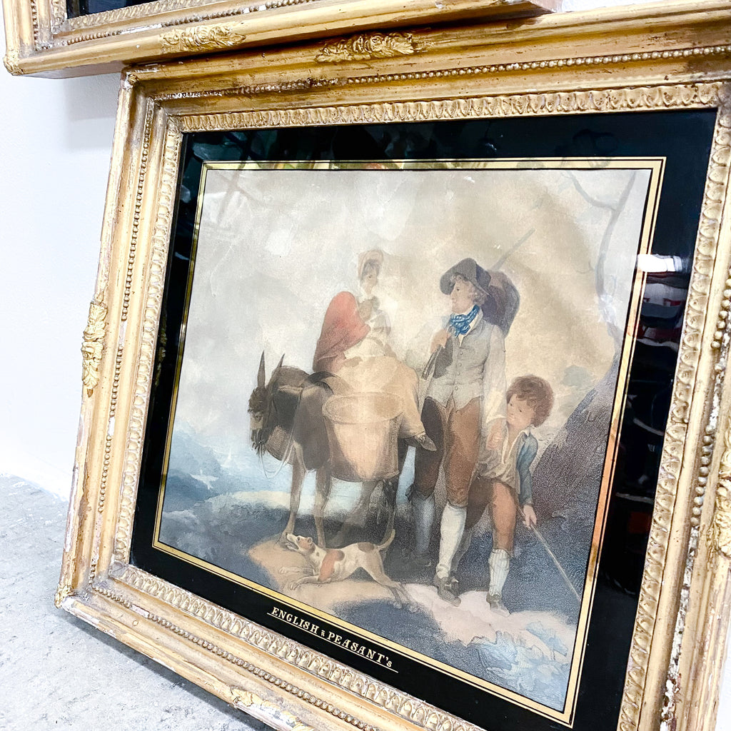Framed artwork of a scene with people and a donkey on a textured surface.