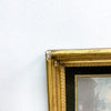 Gold picture frame corner on a white wall