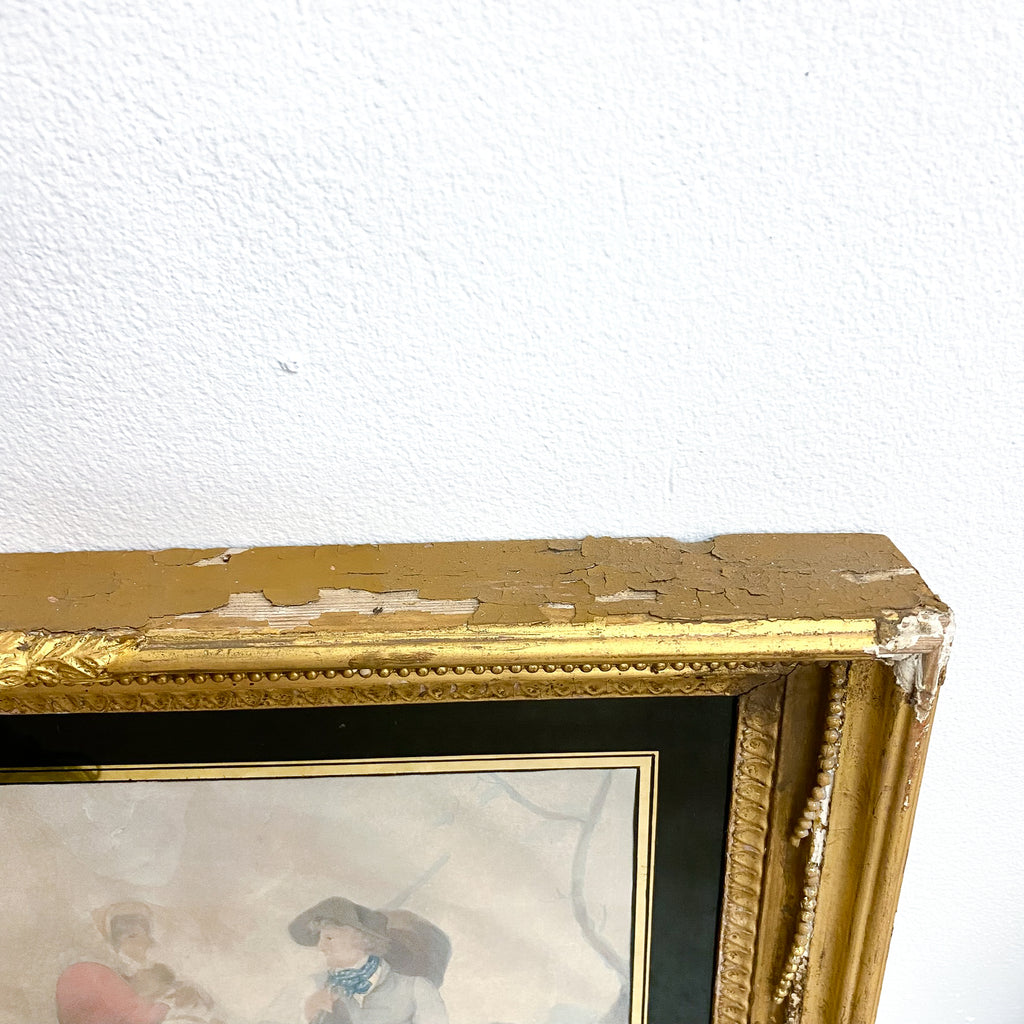 Gold-framed artwork with visible damage on a white wall