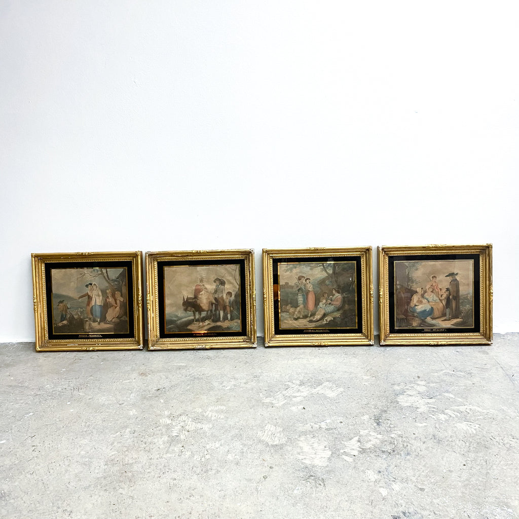 Four framed paintings on a textured white surface