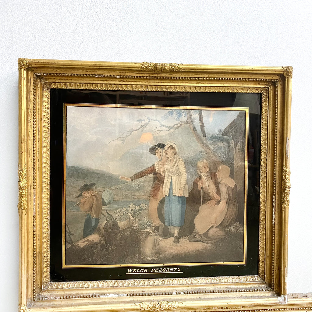 Framed artwork of 'Welsh Peasants' with a gold frame on a white wall.