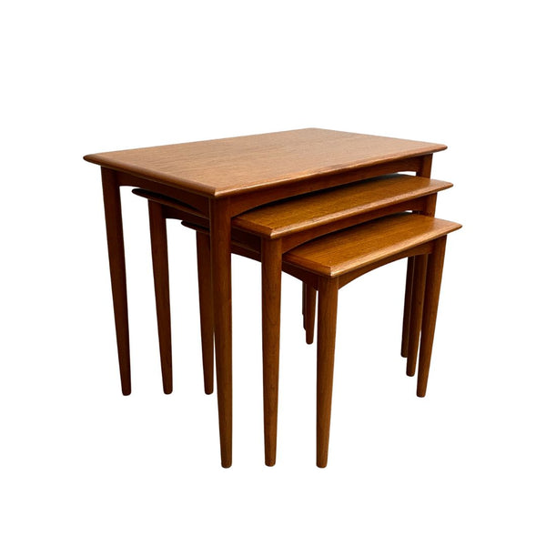 Set of three wooden nesting tables on a white background