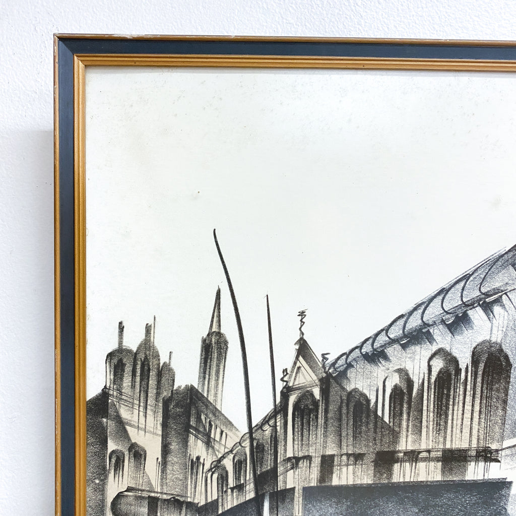 Framed black and white architectural drawing of a cathedral on a white wall.