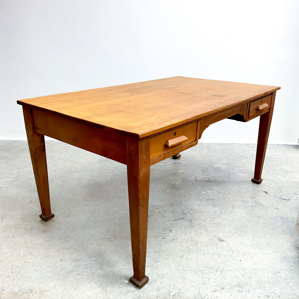 Wooden desk with drawers on a plain background