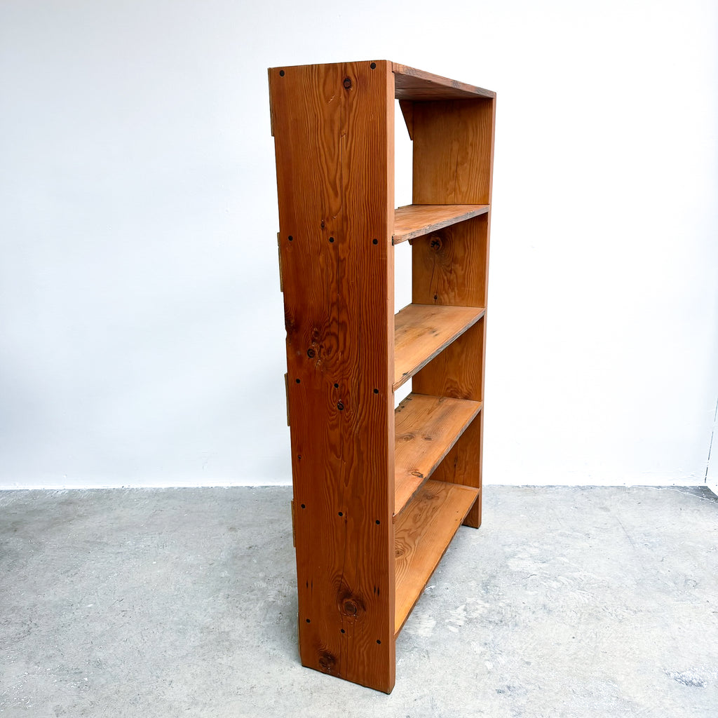 Wooden bookshelf with four shelves on a white background