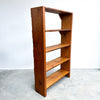 Wooden bookshelf with four shelves on a white background