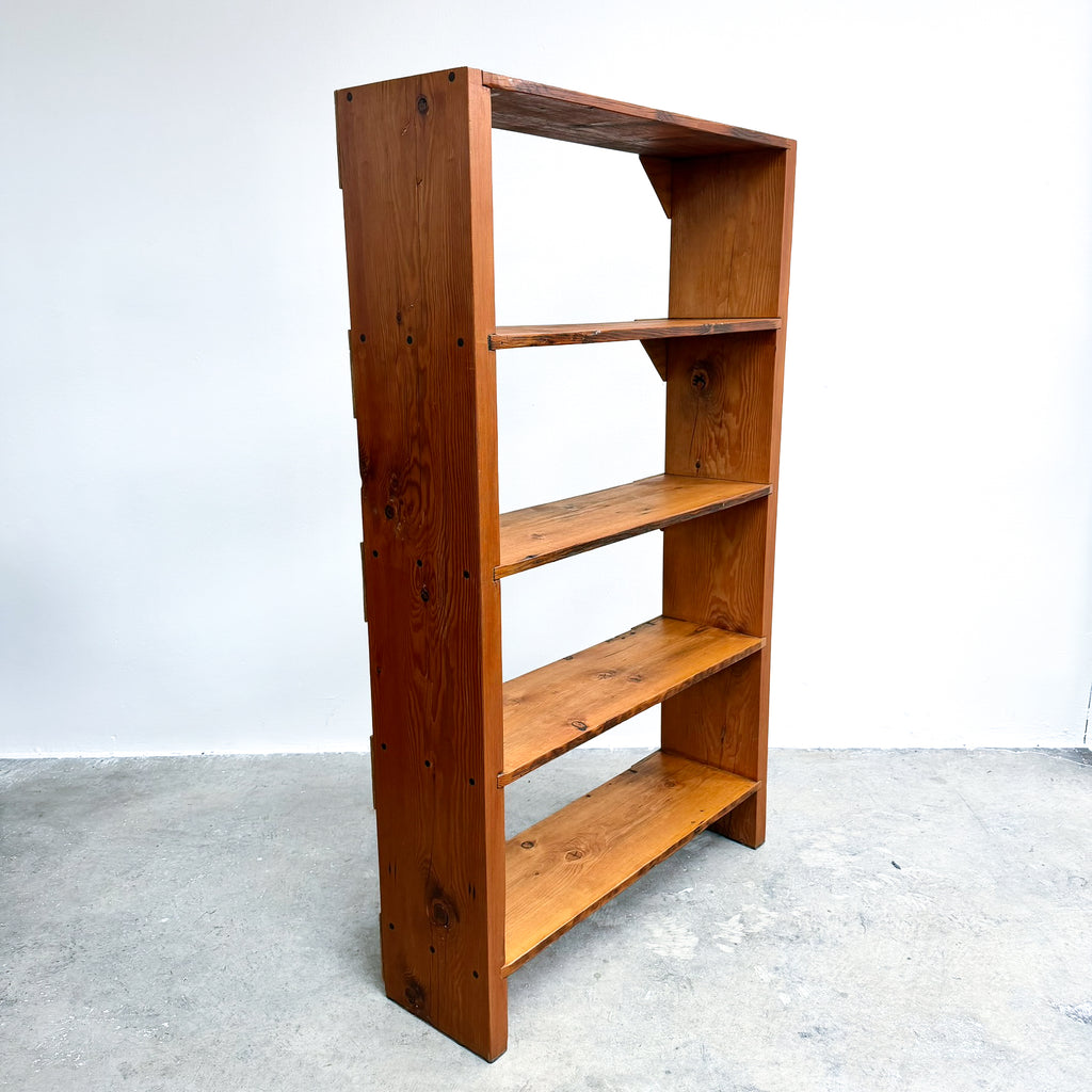 Wooden bookshelf with four shelves on a white background