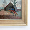 Framed artwork of a cart and building scene with a gold frame.