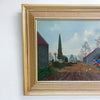 Framed painting of a rural landscape with a red barn and a tree.