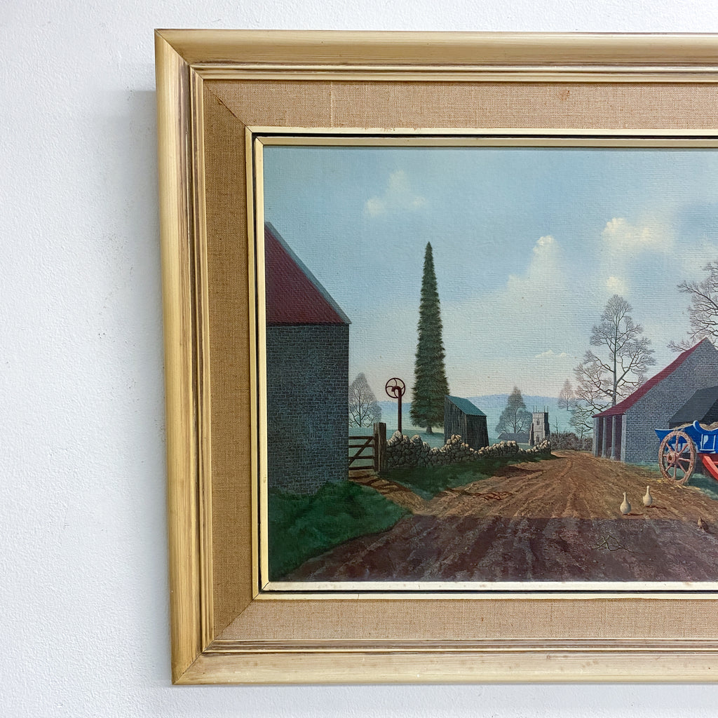 Framed painting of a rural landscape with a red barn and a tree.