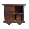 A dark brown wooden cabinet with antique-style black metal corner brackets and hardware, featuring a louvered door, open upper shelf, and two small drawers on the lower right.