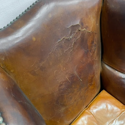 Distressed antique Georgian leather wingback armchair