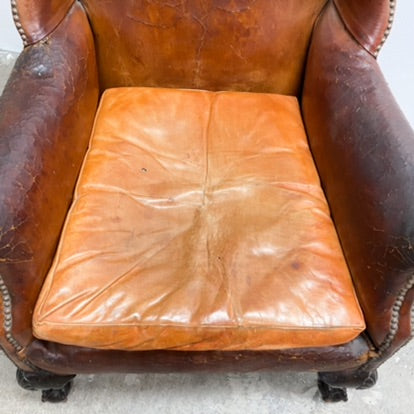 Distressed antique Georgian leather wingback armchair